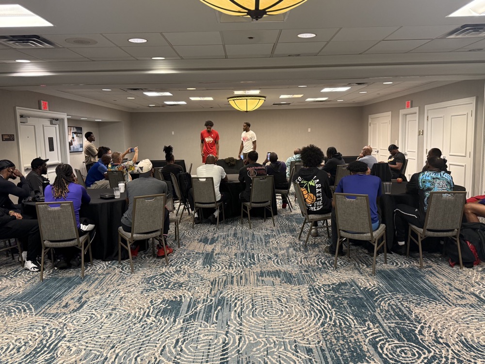 Harlem Wizards team workshop — large group session in a hotel ballroom with participants in Wizards gear