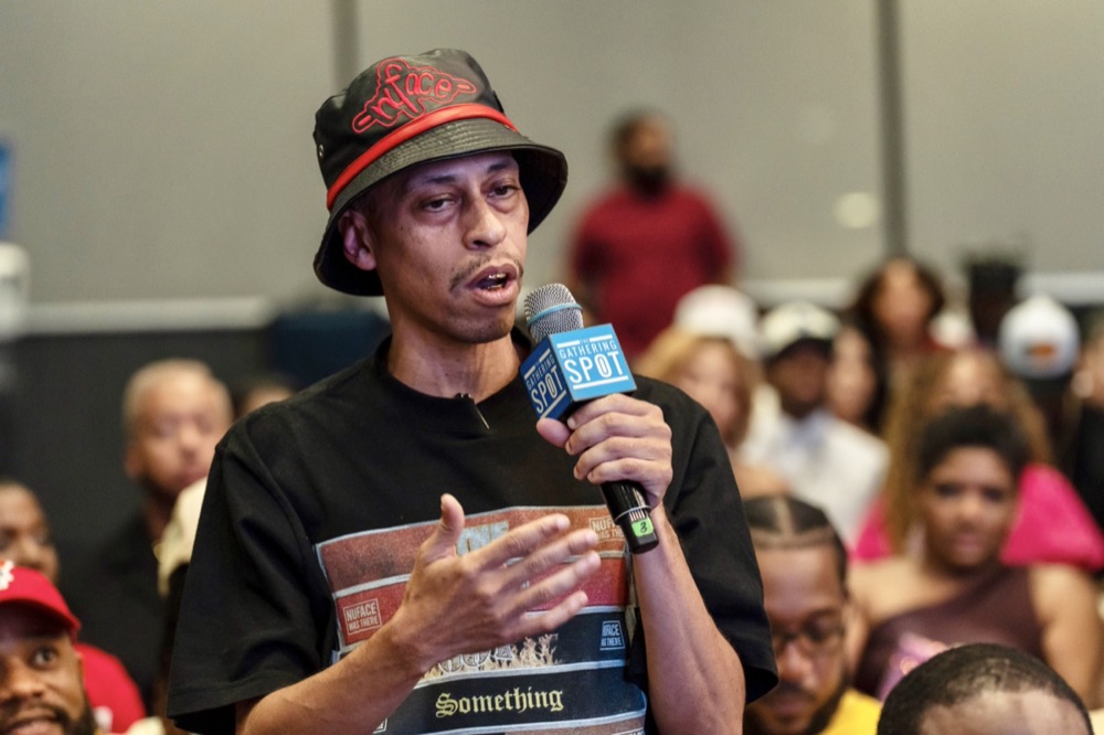 Audience member at microphone during the Red Clay panel discussion at The Gathering Spot